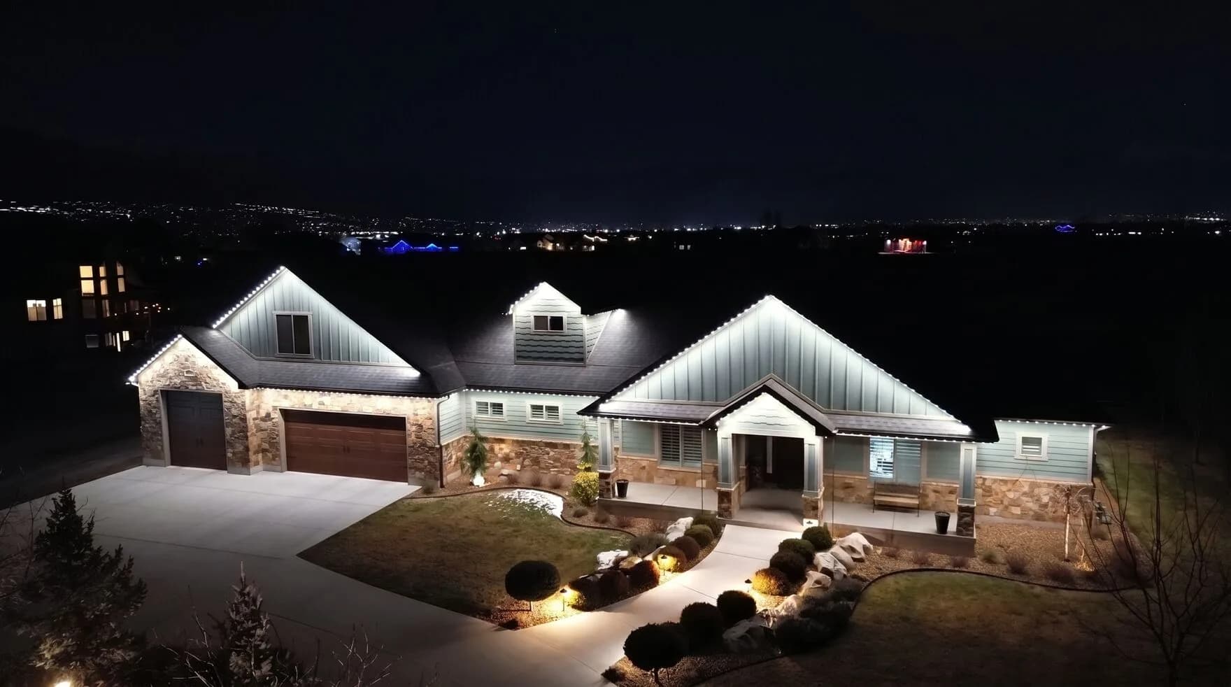 TruLight permanent lighting in cool white on a home at night (TruLight network scene)